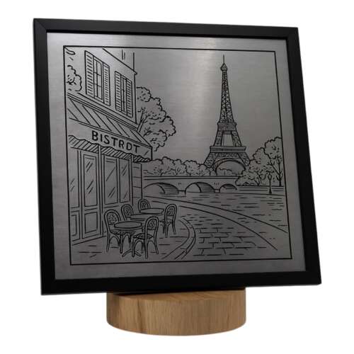 Metal engraving of a Paris bistrot scene with Eiffel Tower and bridge, mounted on a wooden base.