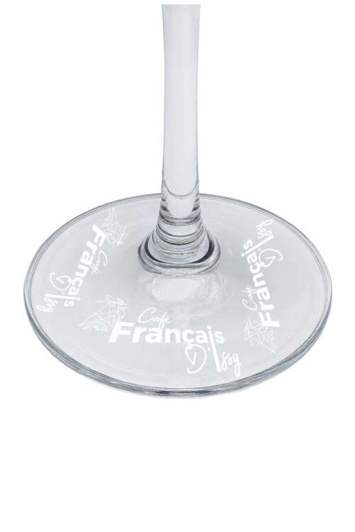 Base of a clear wine glass engraved with the text 'Café Français' and decorative icons.